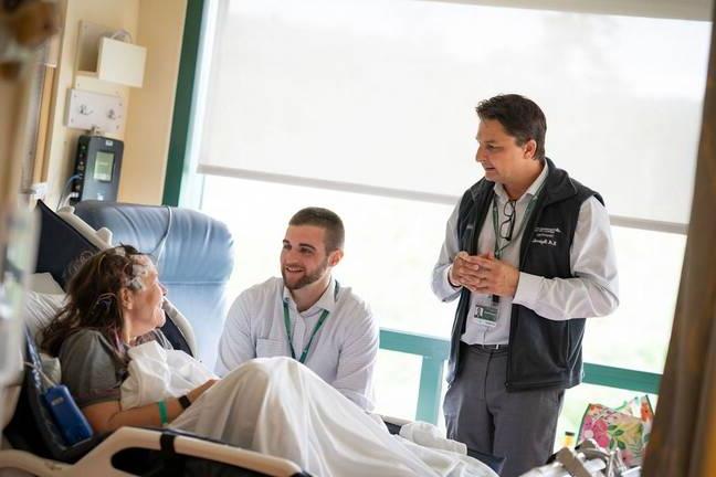 The epilepsy team discusses a care plan with a patient on the epilepsy monitoring unit.